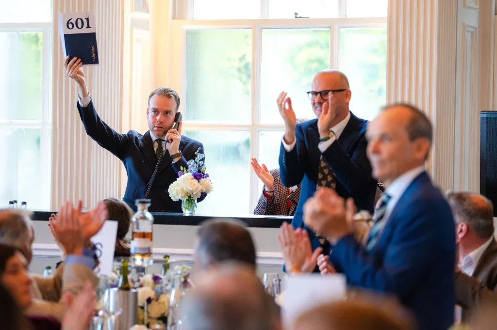 An auctioneer places a bid over the phone