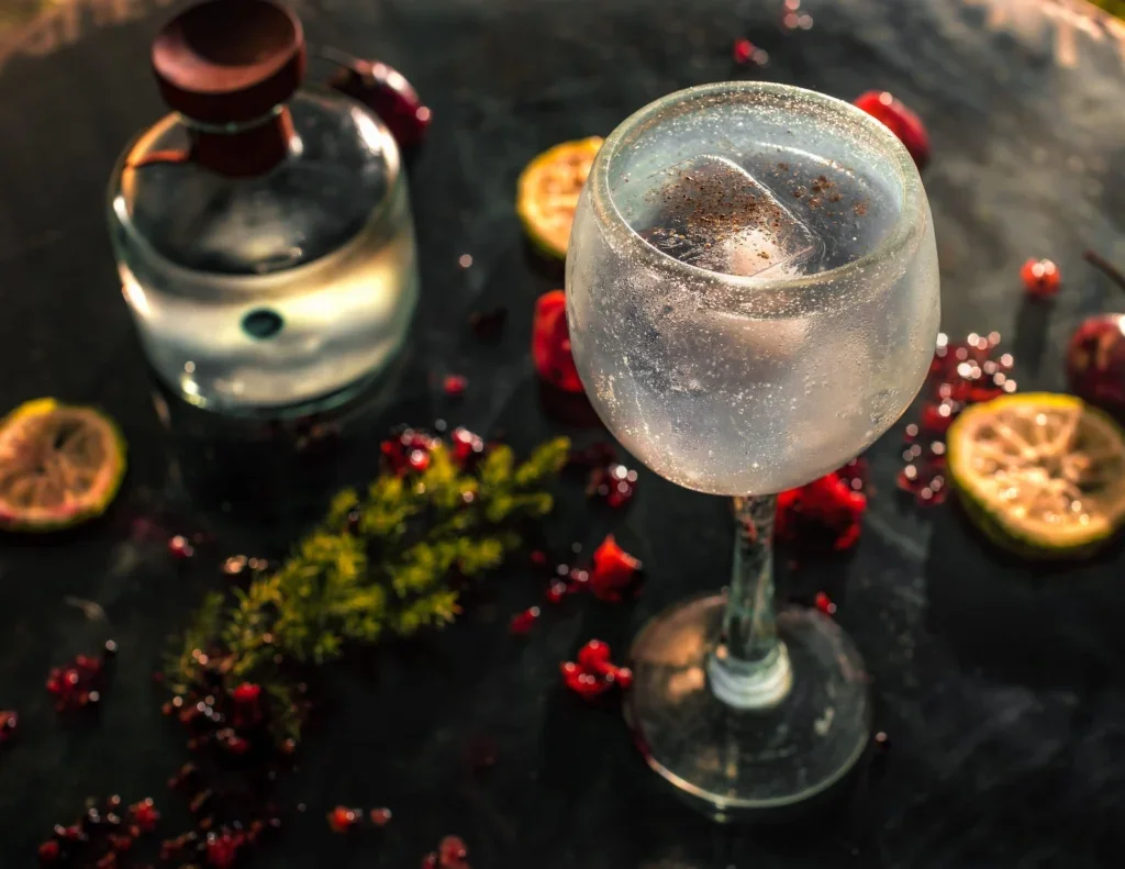 Gin and tonic next to a gin bottle
